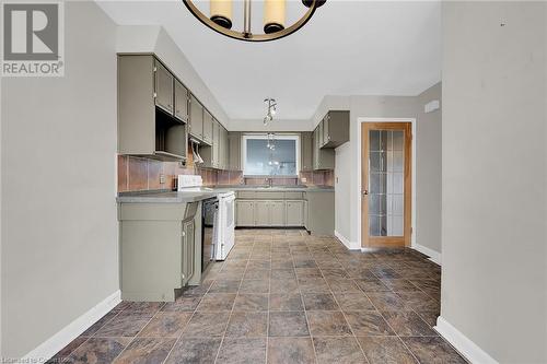Kitchen featuring gray cabinetry, range, and baseboards - 9 Gavin Drive, St. Catharines, ON - Indoor Photo Showing Kitchen