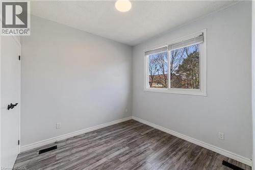 Second bedroom with large window and laminate flooring - 4199 Longmoor Drive Unit# 6, Burlington, ON - Indoor Photo Showing Other Room