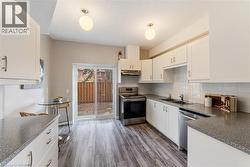 Renovated kitchen with classic white cabinetry - 