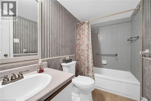 Bathroom featuring tile patterned floors, vanity, shower / bathtub combination with curtain, and toilet - 416 Limeridge Road E Unit# 309, Hamilton, ON - Indoor Photo Showing Bathroom