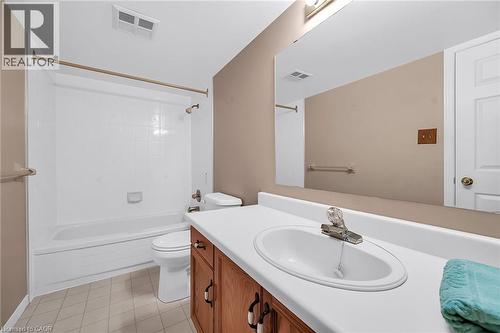 Bathroom featuring vanity, toilet, washtub / shower combination, and visible vents - 416 Limeridge Road E Unit# 309, Hamilton, ON - Indoor Photo Showing Bathroom