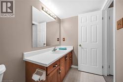 Bathroom with baseboards, tile patterned flooring, and vanity - 
