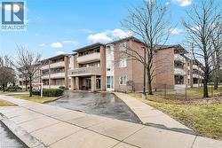 View of building exterior with driveway and fence - 