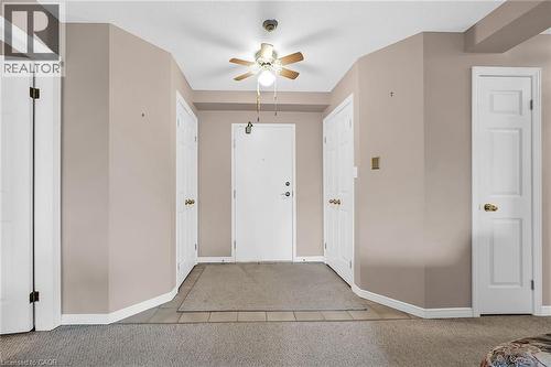 Foyer entrance featuring baseboards, tile patterned flooring, ceiling fan, and carpet floors - 416 Limeridge Road E Unit# 309, Hamilton, ON - Indoor Photo Showing Other Room