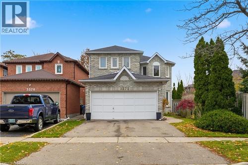 Traditional home featuring asphalt driveway, a garage, and a shingled roof - 3372 Bobwhite Mews, Mississauga, ON 