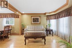 Sitting room featuring ornamental molding, plenty of natural light, and hardwood / wood-style floors - 