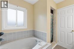 Bathroom featuring a stall shower, a garden tub, and tile patterned floors - 