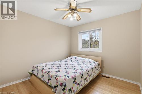 Bedroom with light wood finished floors and a ceiling fan - 3372 Bobwhite Mews, Mississauga, ON 