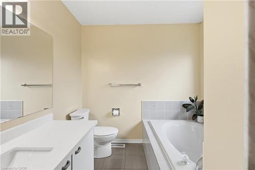 Full bath featuring a bath, vanity, and dark tile patterned flooring - 3372 Bobwhite Mews, Mississauga, ON 