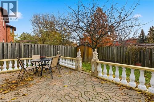 Fenced backyard featuring outdoor dining space and a patio area - 3372 Bobwhite Mews, Mississauga, ON 