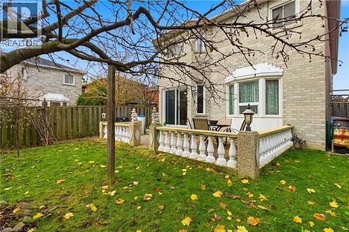 Rear view of house featuring a fenced backyard, a patio, and brick siding - 3372 Bobwhite Mews, Mississauga, ON 