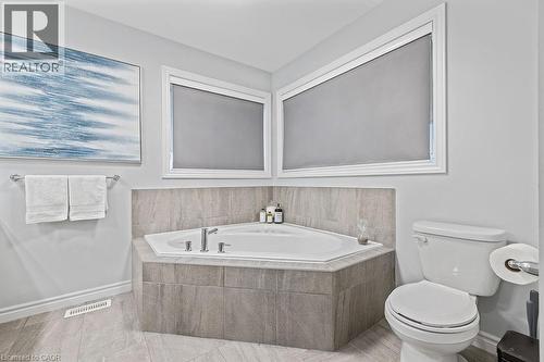 Bathroom with a bath and light tile patterned floors - 4040 Stadelbauer Drive, Beamsville, ON - Indoor Photo Showing Bathroom