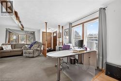 Carpeted office with beamed ceiling - 