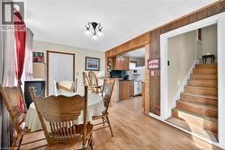 Dining area featuring light wood-style floors and stairs - 