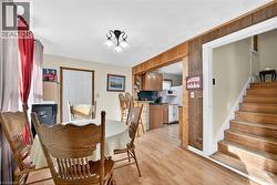 Dining space featuring light wood-style floors and stairway - 