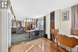 Dining room with wood finished floors and a desk - 