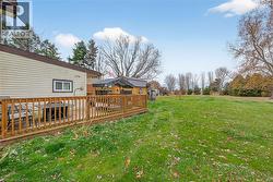 View of grassy yard featuring a deck - 