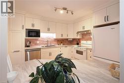 View of kitchen from wall opening above island style cabinet and countertop - 