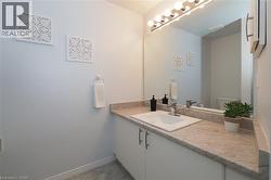 View of large vanity with sink and full sized mirror in 4-piece bathroom - 