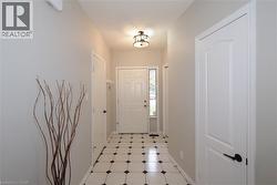 Foyer entrance featuring bright vinyl floor pattern. - 