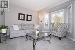 Carpeted living area featuring full length bay windows - 