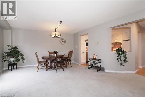 Dining room with light carpet and swagged chandelier - 511 Oakvale Drive Unit# 1, Waterloo, ON - Indoor