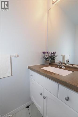 Vanity and mirror in 2-piece bathroom on main floor - 511 Oakvale Drive Unit# 1, Waterloo, ON - Indoor Photo Showing Bathroom