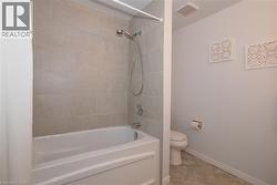 4-piece bathroom featuring brand new bathtub / shower combination with tiled walls - 