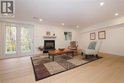 Basement recreation room with recessed lighting, gas fireplace, and French doors to back yard patio - 