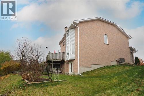 Side view of the home showcasing mostly brick exterior main floor wooden deck, and walkout basement - 511 Oakvale Drive Unit# 1, Waterloo, ON - Outdoor