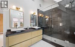 Bathroom with a stall shower, double vanity, and light marble finish flooring - 