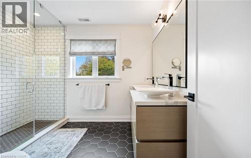 Full bath featuring vanity, dark tile patterned floors, a stall shower, and recessed lighting - 735 George Street, Burlington, ON - Indoor Photo Showing Bathroom