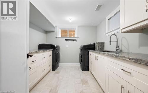 Washroom with washer and clothes dryer and cabinet space - 735 George Street, Burlington, ON - Indoor Photo Showing Laundry Room