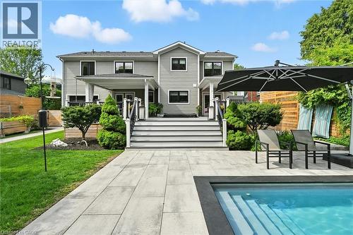 Back of house featuring an outdoor pool, a patio, and a porch - 735 George Street, Burlington, ON - Outdoor With In Ground Pool With Deck Patio Veranda
