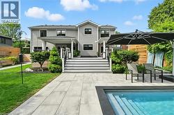 Back of house featuring an outdoor pool, a patio, and a porch - 