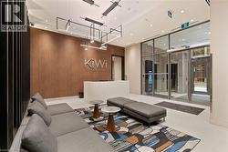 Common area featuring a wall of windows, wooden walls, and recessed lighting - 