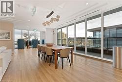 Dining space featuring expansive windows and light wood-style flooring - 