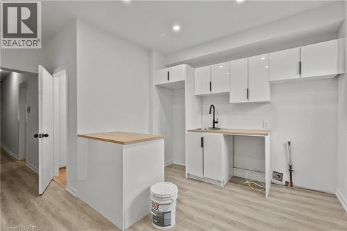 Kitchen featuring white cabinets, modern cabinets, light wood-style flooring, recessed lighting, and butcher block countertops - 246 Mary Street, Hamilton, ON 