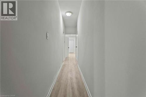 Hallway featuring light wood finished floors and baseboards - 246 Mary Street, Hamilton, ON 