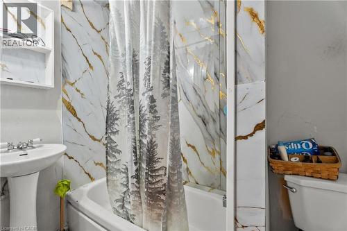 Bathroom featuring toilet and a combined bath / shower with marble appearance - 246 Mary Street, Hamilton, ON 