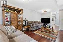 Living area with wood-type flooring and baseboards - 