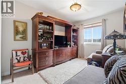 Living area with baseboards and light colored carpet - 