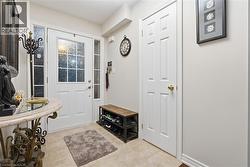 Doorway to outside with tile patterned flooring and baseboards - 