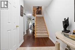 Stairs with hardwood / wood-style flooring and baseboards - 