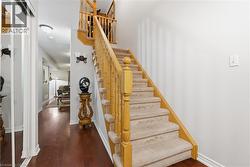 Stairs featuring hardwood / wood-style floors - 
