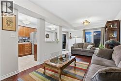 Living area featuring dark wood-style flooring and baseboards - 