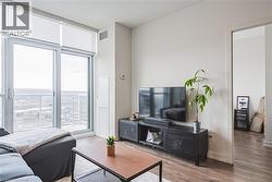 Living area featuring visible vents, wood finished floors, baseboards, and expansive windows - 