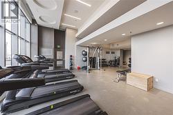 Exercise room with recessed lighting, baseboards, and a towering ceiling - 