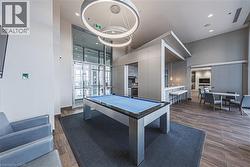 Playroom featuring visible vents, billiards, recessed lighting, a towering ceiling, and wood tiled floor - 