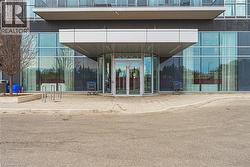 Doorway to property featuring brick siding, central AC unit, and french doors - 